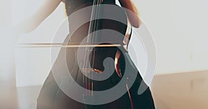 Single woman playing the cello, close-up and medium close-up, cello bow and strings