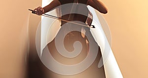 Single woman playing the cello, close-up and medium close-up, cello bow and strings