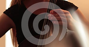 Single woman playing the cello, close-up and medium close-up, cello bow and strings