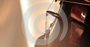 Single woman playing the cello, close-up and medium close-up, cello bow and strings