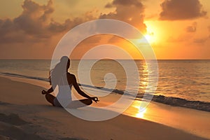 A single woman practicing yoga on a beach, with the sun setting over the ocean