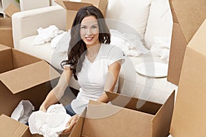 Single Woman Unpacking Boxes Moving House