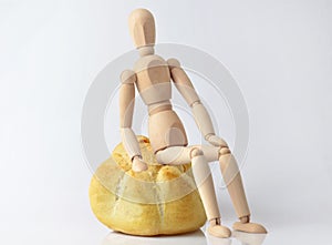 Single wooden puppet sitting on a bun