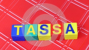 Single word TASSA on wooden block taxes  photo