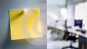 Single yellow post-it note attached to wall with push pin