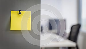 Single yellow post-it note attached to wall with push pin