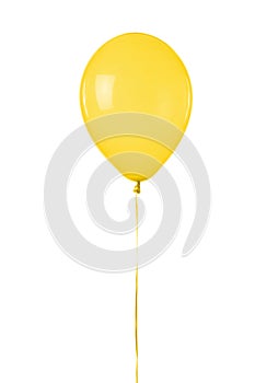 A single yellow toy balloon isolated on a white background