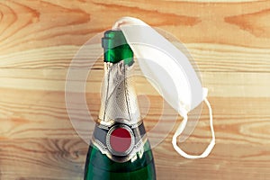 Singular mask in champagne bottle â€“ happy new normal year, coronavirus Christmas.