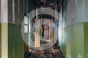 Sinister and creepy Corridor of abandoned hospital after fire. Ceiling in black soot