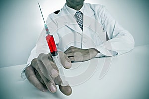 Sinister doctor with a syringe photo