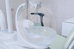 Sink at a dental office. Tools in a dentists office close up background and the chair. Medical equipment and stomatology concept.