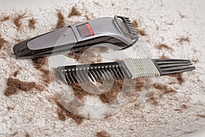 Sink full of hair and dirty comb, trimmer.