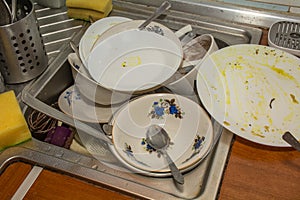 SINK FULL OF UNWASHED DISHES