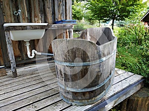 Sink and wooden vintage bathtub in the garden