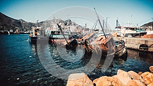 Sinking boat , rust , water and boats