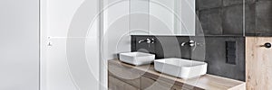 Sinks in elegant white, concrete and wooden bathroom inte