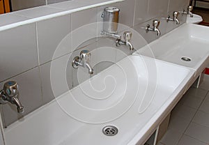 Sinks and washbasins with taps in the toilets of a nursery