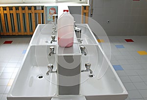 sinks and washbasins with very low taps in the toilets of a nursery