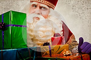 Sinterklaas or saint Nicholas showing gifts