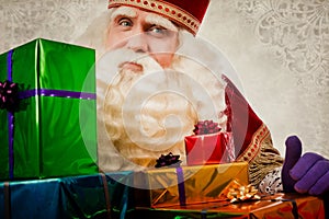 Sinterklaas or saint Nicholas showing gifts photo