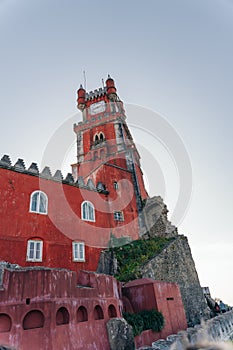 Sintra, Portugal - dec, 2021: Pena National Palace seen from Castle of the Moors with tourists