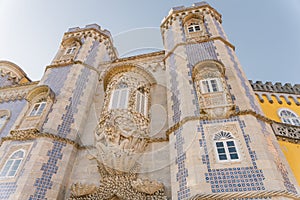 Sintra, Portugal - dec, 2021: Pena National Palace seen from Castle of the Moors with tourists