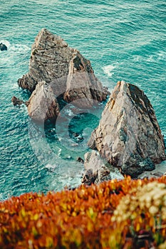 Sintra, Portugal. Sea stack rocks on shore of Praia da Ursa. Atlantic Ocean coastline