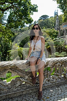 Sintra, Portugal - September 14, 2023. Young woman tourist at gardens in Quinta da Regaleira