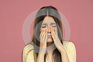 Sinus pain, sinus pressure, sinusitis. Sad woman holding her nose because sinus pain