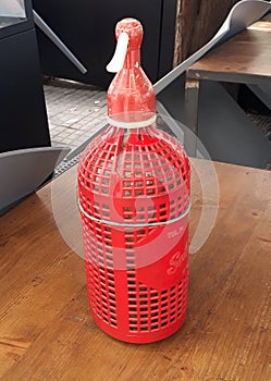 Siphon water bottle red over a bar table. photo
