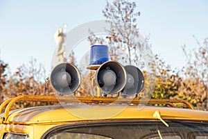 Siren and blue flasher on the roof of an old police car