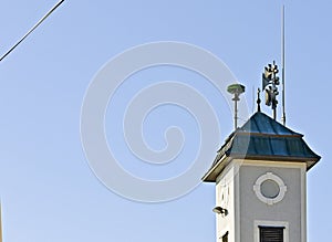 Sirens and an antenna on a tower roof