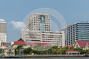 Siriraj hospital building and red roofed houses along Chao Phraya River, Bangkok Thailand