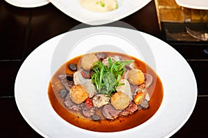 Sirloin beef steak with potato crogettes and arugula salad and g