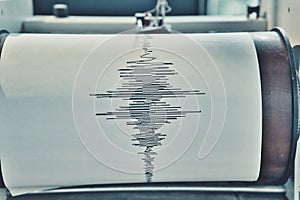 A Sismograph Recording Device with Seismic Waves Traced on Paper