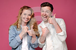 Sister and brother approving doing positive gesture with hand, thumbs up