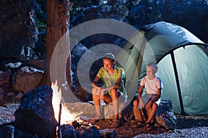 Sister with brother at the campfire