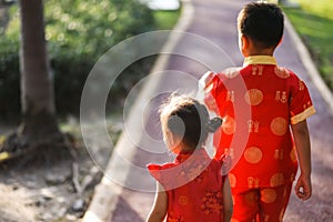 sister and brother in cheongsam dress at park