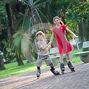 Sister and brother having fun rollerblading