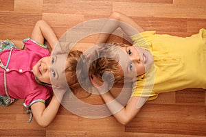 Sister and brother lie on floor