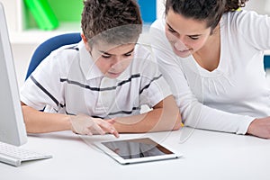 Sister and brother playing game on tablet pc