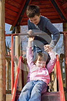 Sister And Brother On Slide