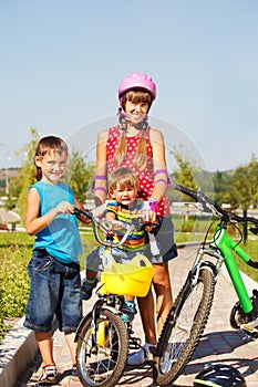 Sister and brothers with bicycles