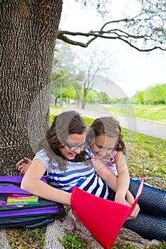 Sister firends girls relaxed under tree park after school