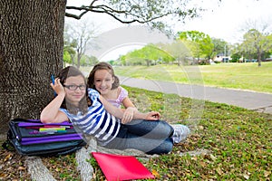 Sister firends girls relaxed under tree park after school