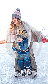 Sister with little nephew, boy 3-5 years old, winter city ice rink, happy ones ride, have fun playing studying weekend