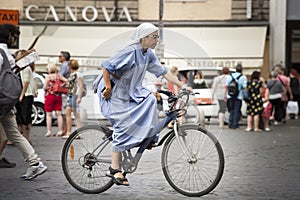 Sister nun cycling in the cities. On bicycle