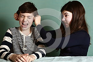 Sister pull brother ear as a loss in argument