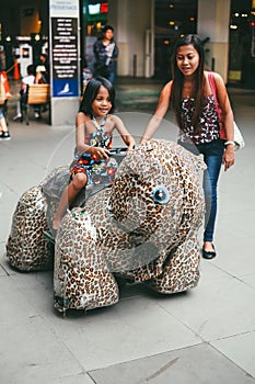 Sister`s bonding in Luna park riding a toy car