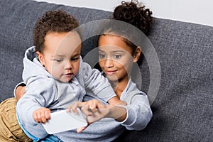 Sister taking selfie with little brother